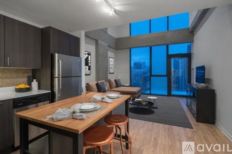 A modern kitchen with a dining table set for two.