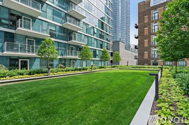 A grassy area in front of a modern building.