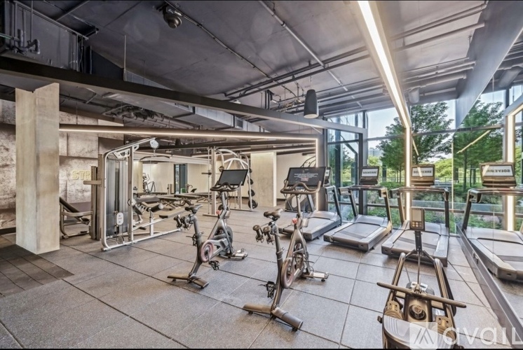 A gym with treadmills, exercise bikes, and other equipment.