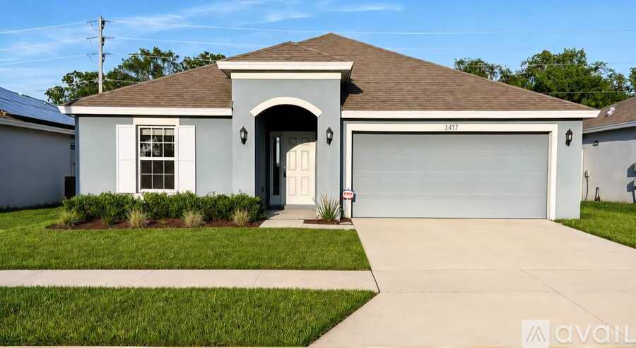 A house with a brown roof and a white garage door.
