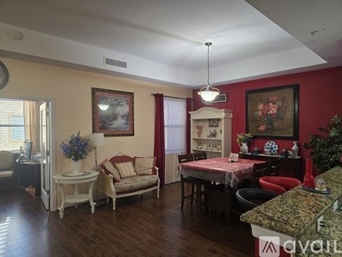 A living room with a sofa, chair, and a table with a lamp on it.