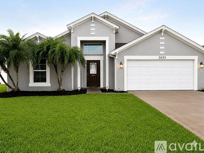 A modern house with a white garage door and a black door.