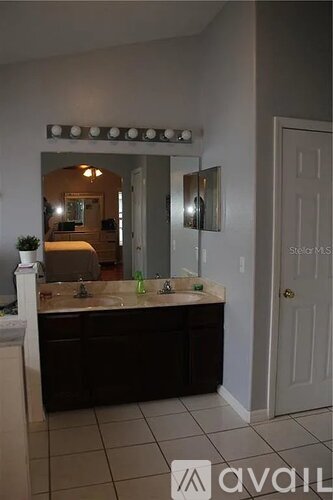 A bathroom with a vanity and a mirror.