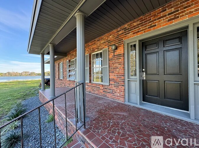 A house with a brick facade and a black door.