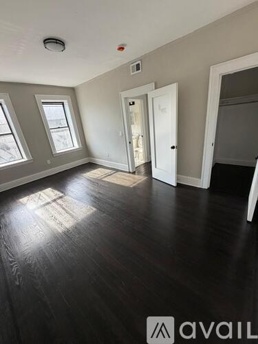 A room with wooden floors and white walls.