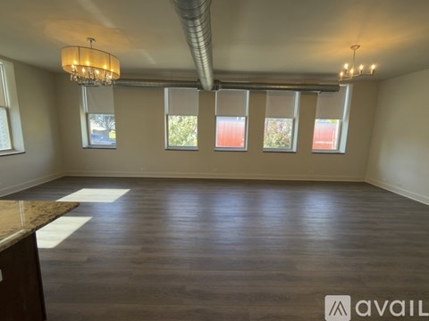 A room with wooden floors and a chandelier.
