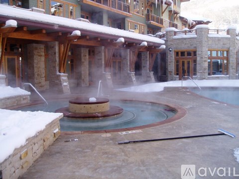 A hot tub in the middle of a snowy area.