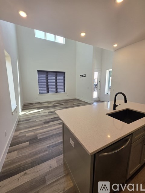 A kitchen with a sink and a counter top.