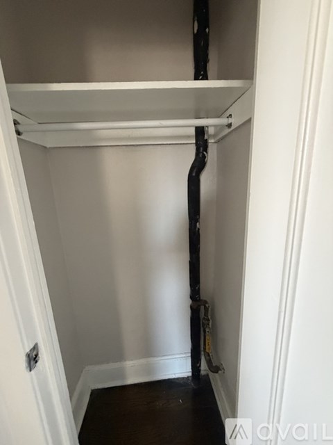 A white shelf in a narrow hallway.