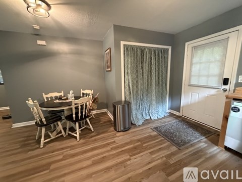 A dining room with a table and chairs.