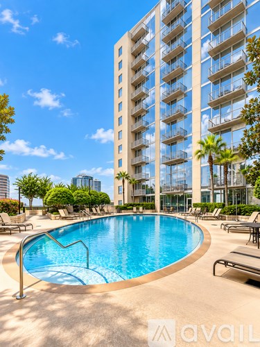 A large pool in front of a tall building with a logo that reads "avaiL".