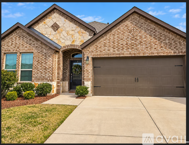 A house with a garage door and a driveway.