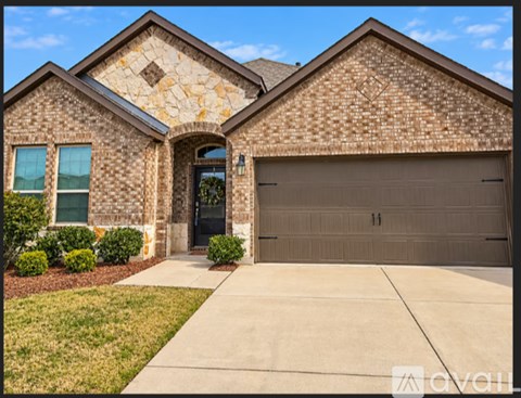 A house with a garage door and a driveway.