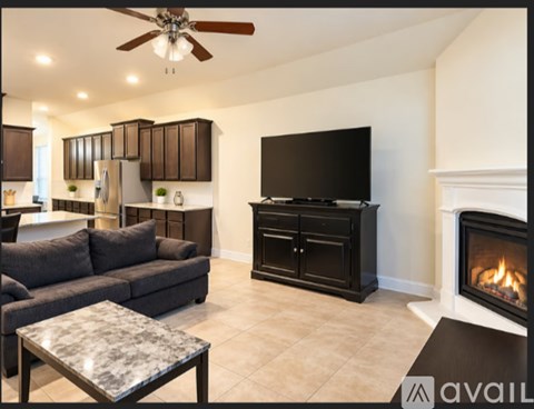 A modern living room with a fireplace and a flat screen TV.