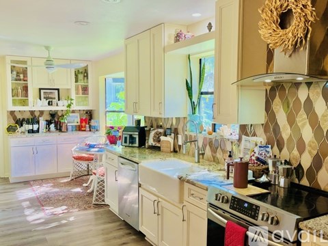 A kitchen with a stove top oven and a microwave.