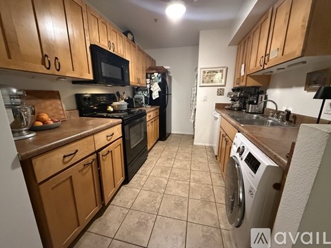 A kitchen with wooden cabinets and a washing machine.