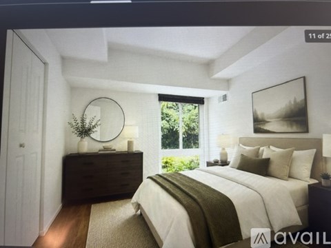 A bedroom with a large bed and a mirror on the wall.
