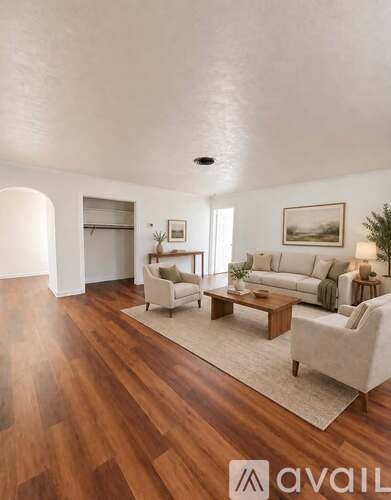A living room with a couch, chair, and coffee table.
