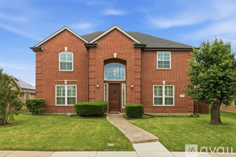 A red brick house with a brown door and windows.