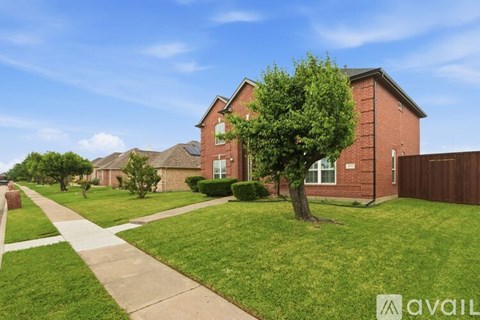 A house with a tree in front of it.