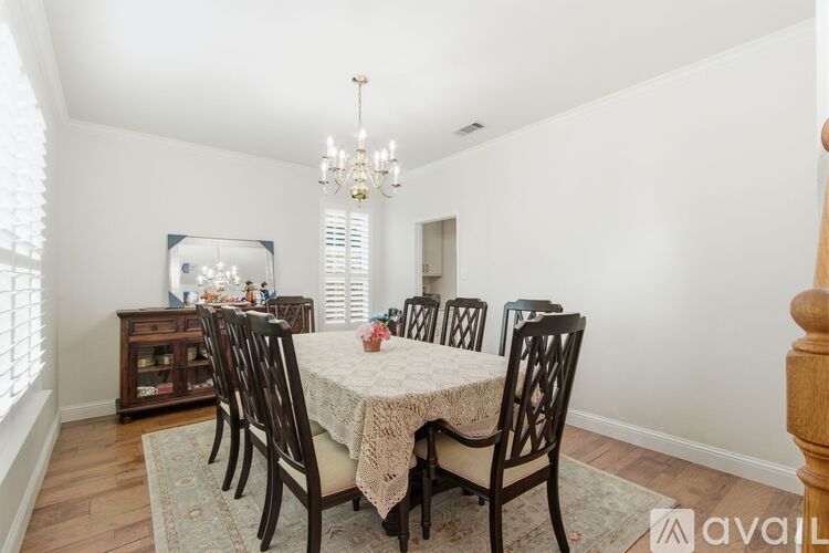 A dining room with a table set for six people.