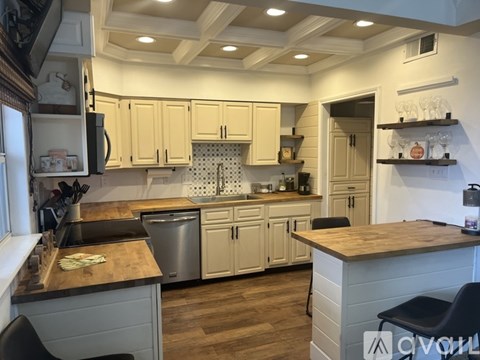 A kitchen with wooden cabinets and a wooden counter top.