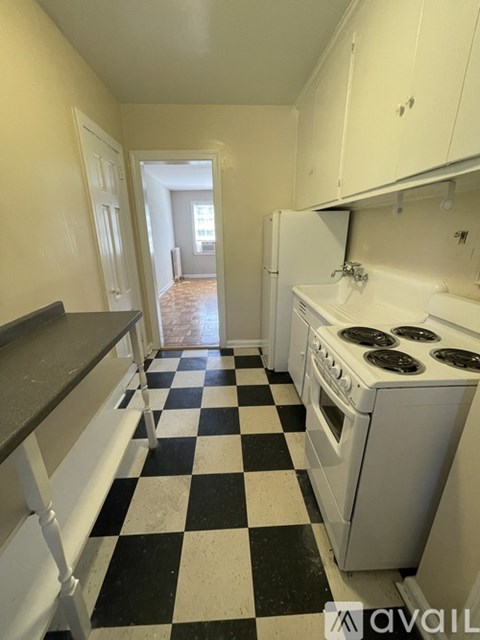 A kitchen with black and white checkered floor.
