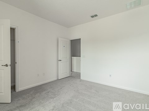 A room with two doors and a carpeted floor.