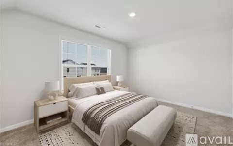 A bedroom with a large bed and a window overlooking a cityscape.