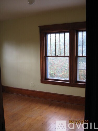 A room with a window and wooden floors.