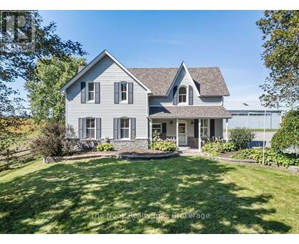 A house with a well-kept lawn in front of it.