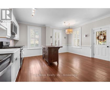 A kitchen with white cabinets and a wooden island.