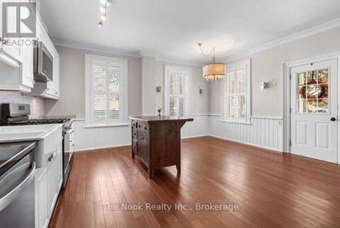 A kitchen with white cabinets and a wooden island.