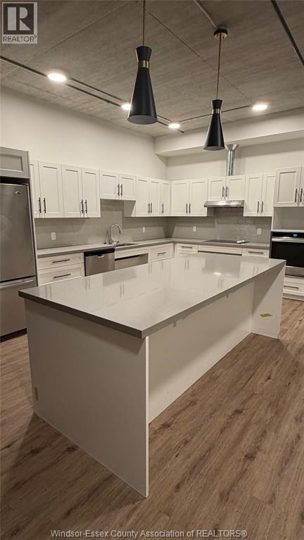 A kitchen with a large island in the middle.