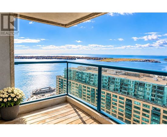 A balcony with a view of a body of water and buildings.