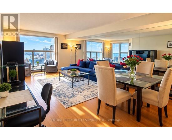 A well-lit living room with a dining table and chairs.