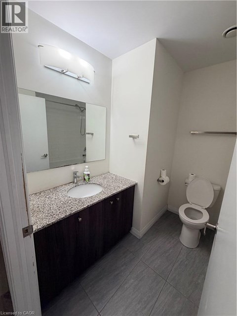 A bathroom with a sink, mirror, and toilet.