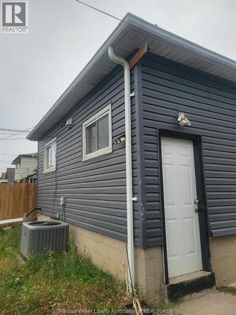 A small house with a white door and a window is shown.