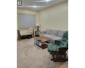 A living room with a couch, chair, and coffee table.