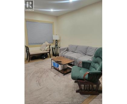 A living room with a couch, chair, and coffee table.