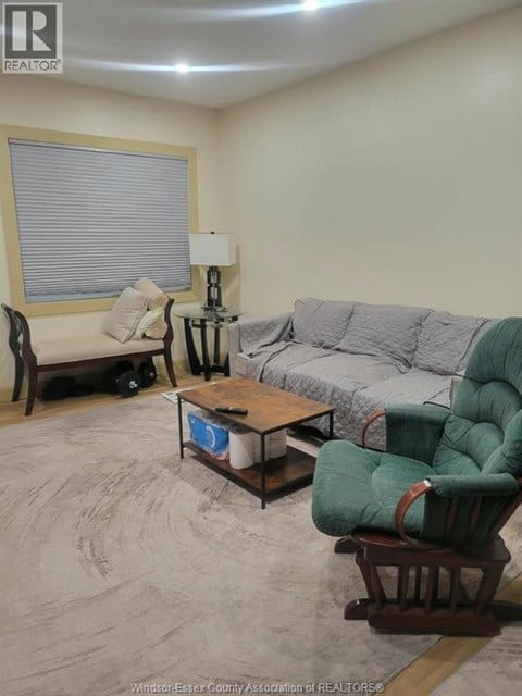 A living room with a couch, chair, and coffee table.