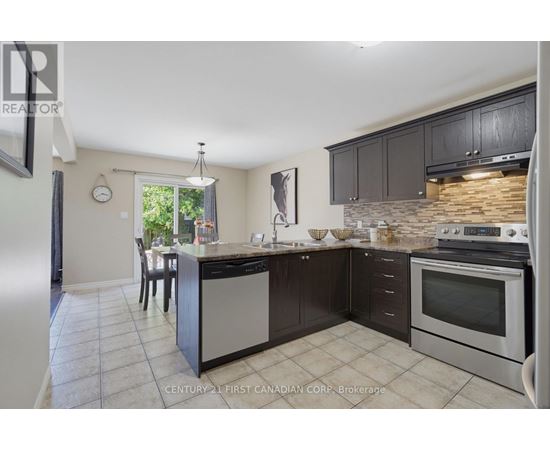 A kitchen with a stove top oven and a dishwasher.