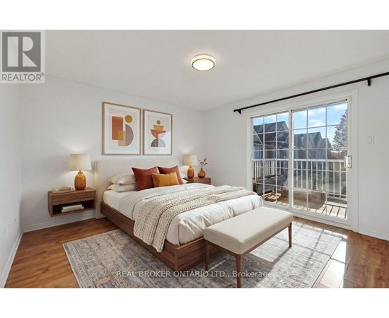 A bedroom with a large bed and a balcony overlooking a city.