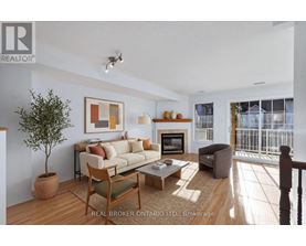 A living room with a couch, chair, and a potted plant.