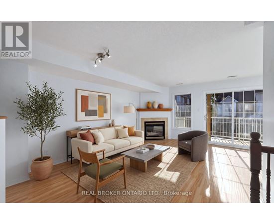 A living room with a couch, chair, and a potted plant.