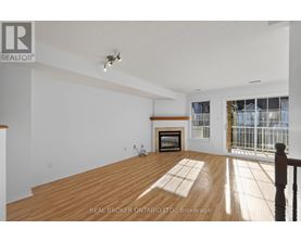 A spacious room with a fireplace and a balcony.