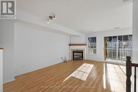 A spacious room with a fireplace and a balcony.