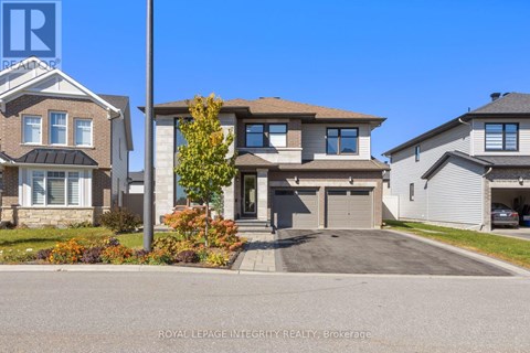 A house with a grey roof and a white garage door is for sale.