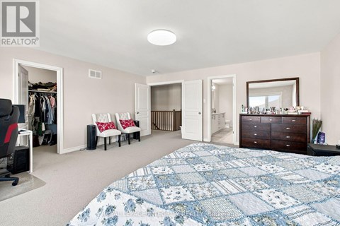 A bedroom with a large bed and a dresser.