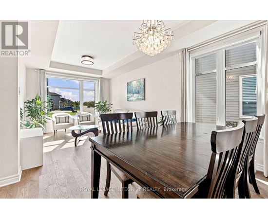 A dining room with a wooden table and chairs.
